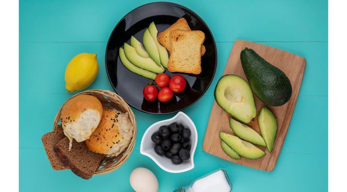 Top View Fresh Avocados Wood Kitchen Board With Avocado Slices Tomatoes Black Plate With Bucket Breads Blue